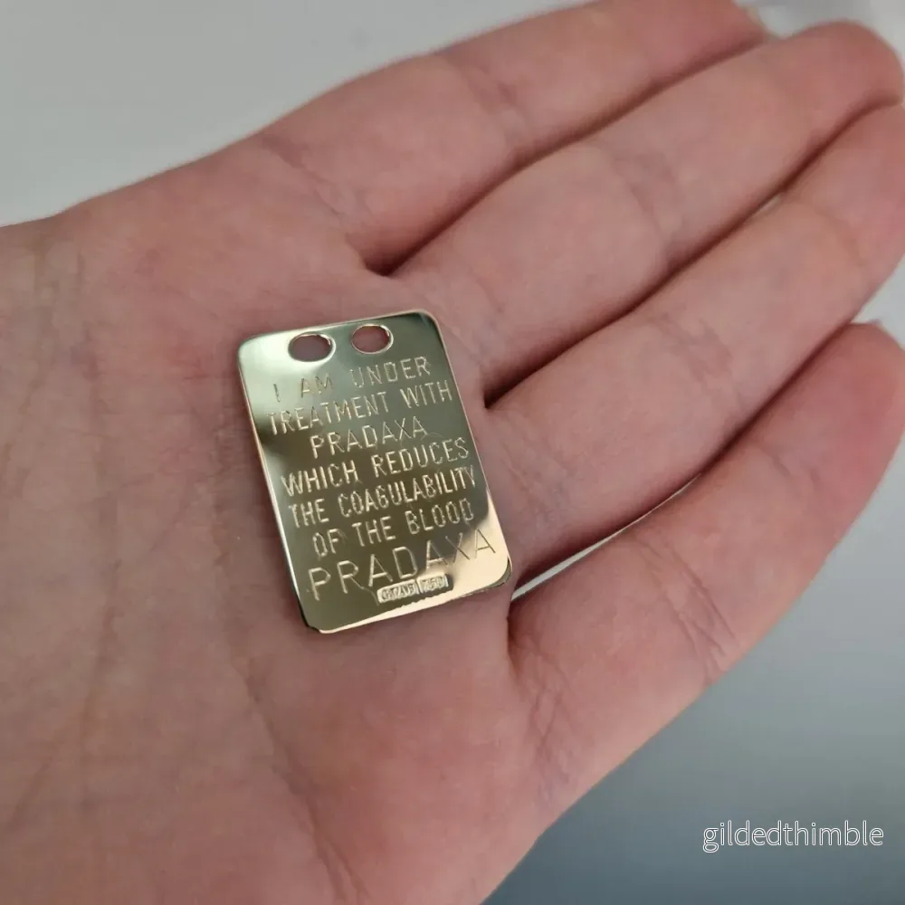 Pradaxa bricka i 18k guld Pradaxa bricka i 18k guld