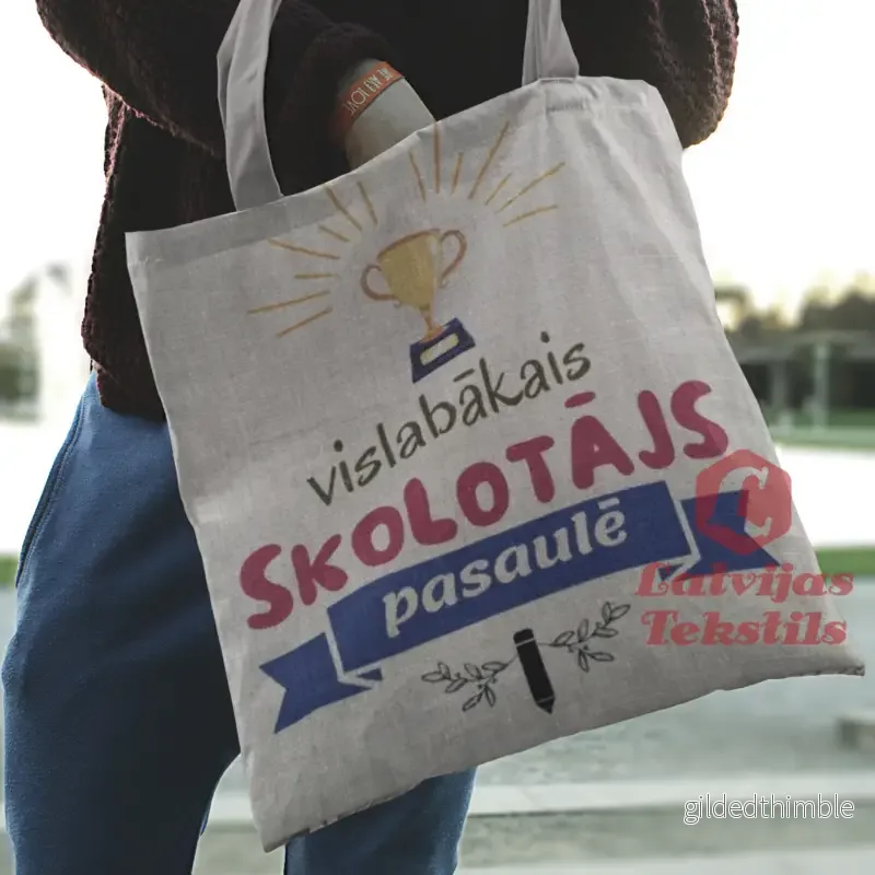Pelēka lina auduma maisiņš «Vislabākais skolotājs pasaulē» | kolekcija «Māci.Mīli.Iedvesmo.»