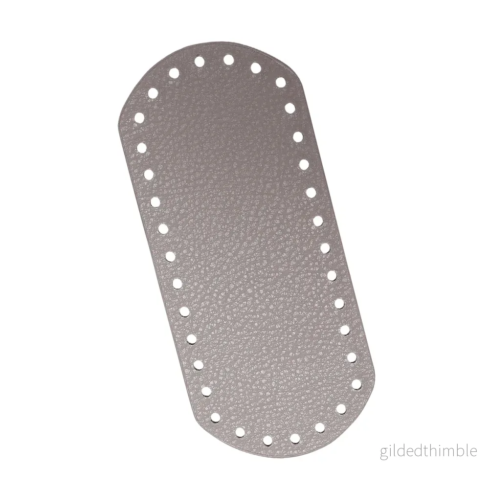 Väskbotten i gråbeige konstläder 18,5×8 cm.
