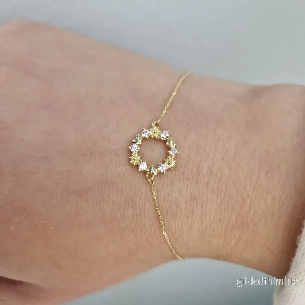 Armband i 18k guld med krans och stenar Armband i 18k guld med krans och stenar