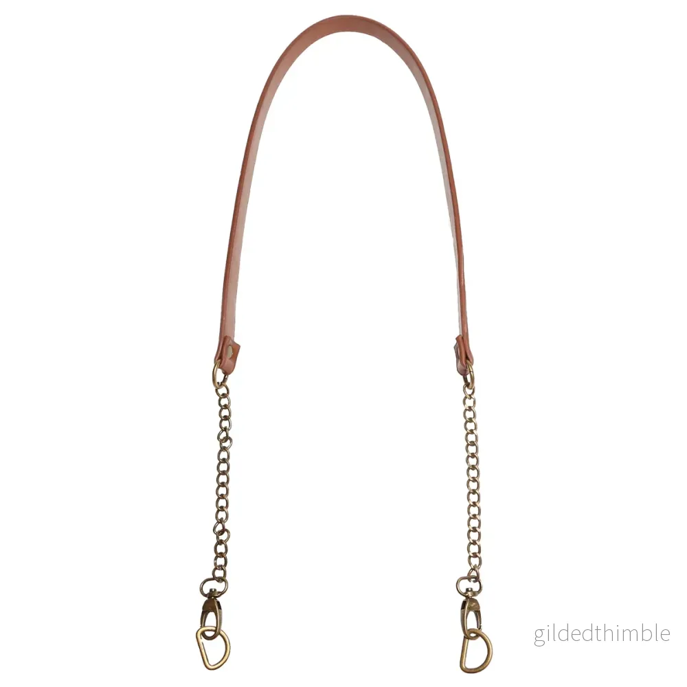 Axelrem i konstläder 102 cm. x 12 mm. – Brun med bronskedja och D-ring Axelrem i konstläder 102 cm. x 12 mm. – Brun med bronskedja och D-ring